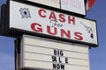 Cash for Guns sign at a gun shop. In hard economic times, people sell, pawn or consign guns and weapons for quick cash