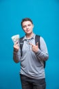 Cash loan, first easy money and spending money. The boy teenager holds in the hands the earned money. Earnings or winnings online