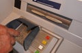 Cash machine, cash dispenser, automatic teller.Male person types the secret code in the ATMs