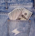 Cash, money is in the pocket of blue jeans. Money in pocket. Man hand is putting money in the pocket. Dollars Royalty Free Stock Photo