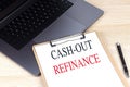 CASH-OUT REFINANCE text on clipboard on laptop Royalty Free Stock Photo