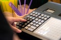 cash register installed on counter for accepting order from customer.sales man entering amount on electronic cash register in Royalty Free Stock Photo