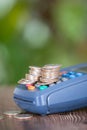 A cash register and a pile of dollar coins on it Royalty Free Stock Photo