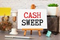 Cash sweep lettering on craft paper, money in the background.