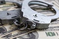 Cash in US Dollars, Real Handcuffs. The Concept of Arrest, Corruption, Bail, Crime, Bribery or Fraud