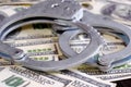 Cash in US Dollars, Real Handcuffs. The Concept of Arrest, Corruption, Bail, Crime, Bribery or Fraud.