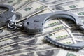 Cash in US Dollars, Real Handcuffs. The Concept of Arrest, Corruption, Bail, Crime, Bribery or Fraud.