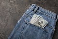 Cash in your pocket. Hundred dollar bills sticking out of the back pocket of blue jeans. Royalty Free Stock Photo