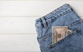 Cash in your pocket. Hundred dollar bills sticking out of the back pocket of blue jeans. Royalty Free Stock Photo