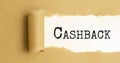 cashback. text on white paper on torn paper