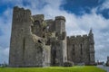 Tourists admiring and sightseeing majestic ancient ruins of Rock of Cashel castle