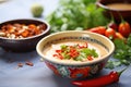 cashew chipotle dressing in ceramic bowl, chili pepper side