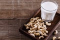 Cashew milk over rustic wooden background