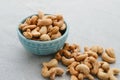 Cashew Nut, in Indonesia known as Kacang Mete. Served in a small bowl on grey background.