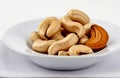 Cashew nut in plate, cut out on white background