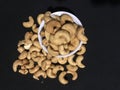 Cashew Nuts, deep fried and in the black background.