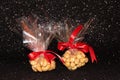 Cashew nuts and hazelnuts in a package on a black shiny background. Hazelnut Royalty Free Stock Photo