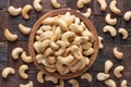 Cashew nuts peeled roasted in wooden bowl, top view