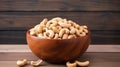 cashew nuts peeled roasted in wooden bowl on rustic table, top view. Royalty Free Stock Photo