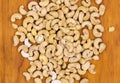 Cashew nuts on wooden background, top view photo. Tasty healthy snack. Scattered nut on table