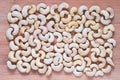 Cashew pile closeup. Cashew on board photo background. Organic food rustic banner template