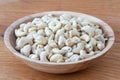 Cashews in a wooden bowl. Nuts are healthy food. Wooden background. Cashew kernel.