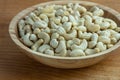 Cashews in a wooden bowl. Nuts are healthy food. Wooden background. Cashew kernel.