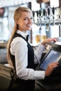Cashier, barista and portrait of woman waiteress in cafe checking for payment receipt. Hospitality, server and young Royalty Free Stock Photo