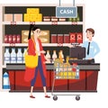 Cashier behind the cashier counter in the interior supermarket with woman buyer shop, store, shelves food products