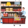 Cashier behind the cashier counter in the interior supermarket, shop, store, shelves food products, goods. Grocery cart Royalty Free Stock Photo