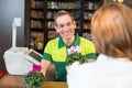 Cashier in flower shop serving client Royalty Free Stock Photo