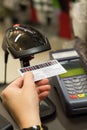 Cashier's hand scanning barcode on member card with credit card