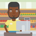 Cashier standing at the checkout in supermarket. Royalty Free Stock Photo