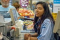 Cashier in the supermarket. Shopping, sale, consumerism and people concept