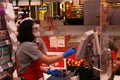 Cashier of Top supermarket working with hygienic masked and face shield and wear gloves to prevent coronavirus or Covid 19