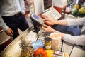 Cashier Using Payment Terminal in Supermarket