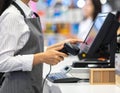 Cashier Using Point of Sale System at Checkout Counter Royalty Free Stock Photo