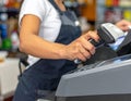 Cashier Using Scanner at Checkout Counter in Retail Store Royalty Free Stock Photo