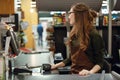 Cashier woman on workspace in supermarket shop Royalty Free Stock Photo