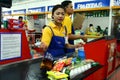 Cashiers and bagger boys in a grocery store in the philippines Royalty Free Stock Photo