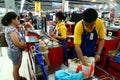 Cashiers and bagger boys in a grocery store in the philippines Royalty Free Stock Photo