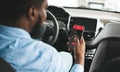 Cashless technology or digital payment for fuel energy. Black guy using mobile app to buy petrol online inside his car Royalty Free Stock Photo