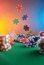 Casino background. Poker chips fall on the table. Against the background of chips and money. Creative light Royalty Free Stock Photo