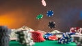 Casino background. Poker chips fall on the table. Against the background of chips and money. Creative light Royalty Free Stock Photo