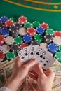 Casino background, straight flush cards at the player and dollars and chips on the poker table. Gaming business, success. Vertical Royalty Free Stock Photo