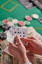 Casino background, straight flush cards at the player and dollars and chips on the poker table. Gaming business, success. Vertical Royalty Free Stock Photo