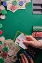 Casino background, two aces cards with a player and dollars and chips on the poker table. Gaming business, success. With space for Royalty Free Stock Photo