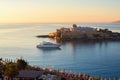 Casino building and white yacht on calm sea level in golden morning sun. St. Georges ÃÂ´s bay, St. Julian ÃÂ´s, Malta. Royalty Free Stock Photo