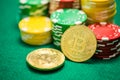 Casino chips and bitcoin cryptocurrency on green table Royalty Free Stock Photo