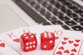 Casino chips, cards and dices stacking on laptop